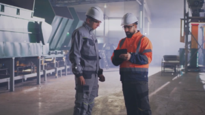 Inspector speaking with worker